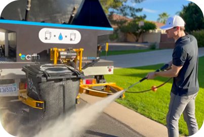 A man using turf cleaning equipment on a turf.